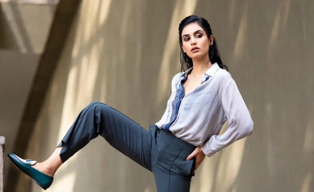 Women showing the loafers with smart casual outfit.